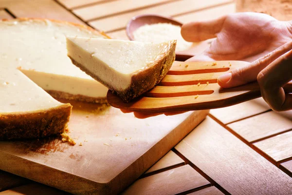 Hands taking piece of freshly baked cheesecake. Homemade dessert — Stock Photo, Image