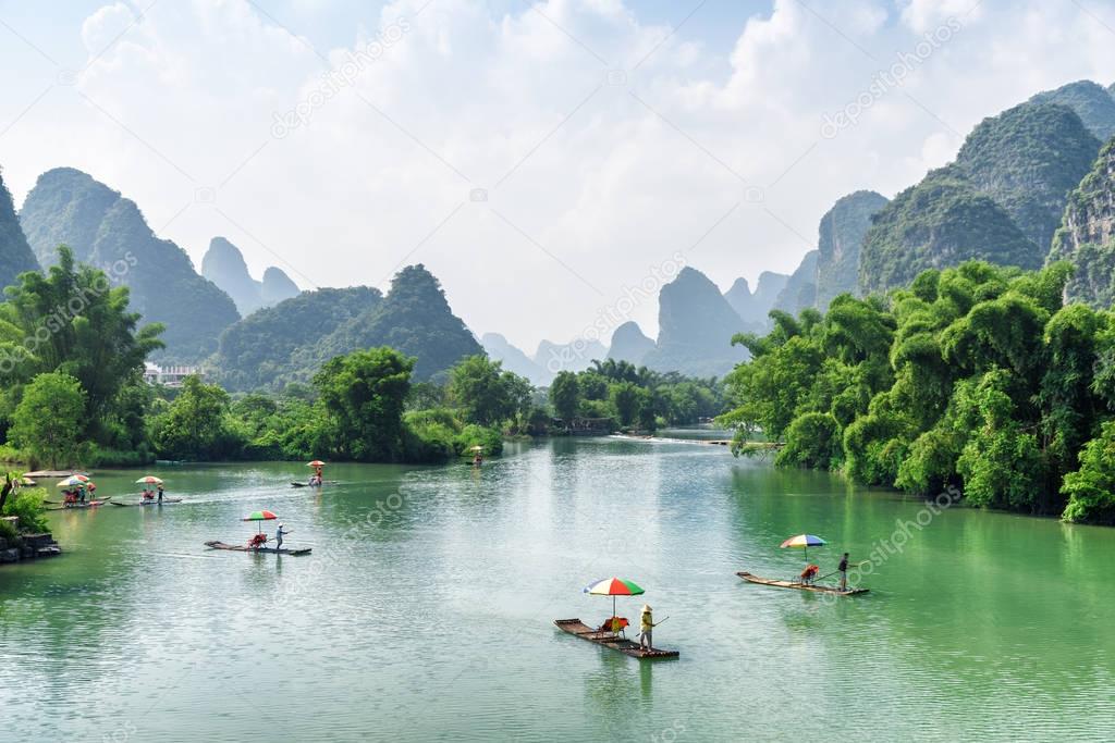 View of tourist bamboo rafts sailing along the Yulong River