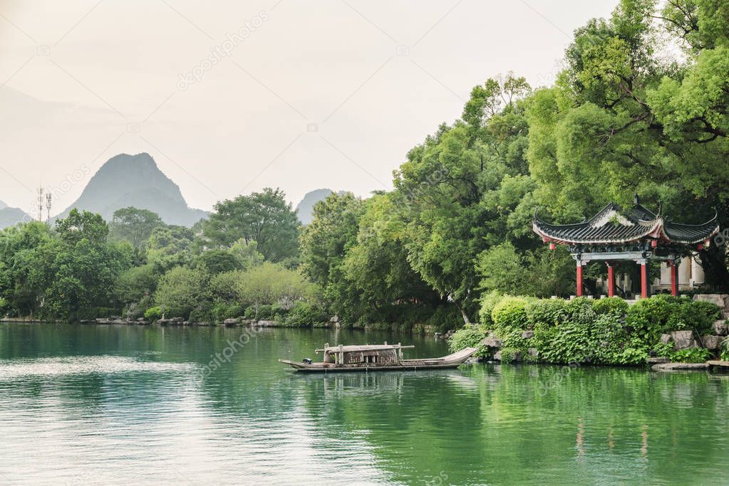 Evening view of traditional Chinese pavilion by lake, Guilin