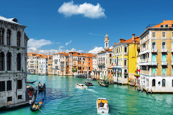 The Grand Canal with gondolas and boats. Colorful houses, Venice