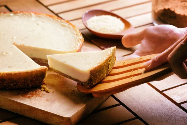 Hands taking piece of freshly baked cheesecake. Sweet dessert — Stock Photo, Image