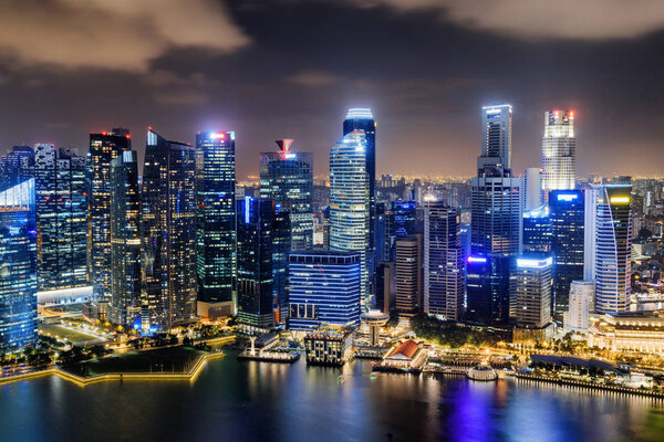 Wonderful night view of skyscrapers at downtown of Singapore. Colorful city lights reflected in water of Marina Bay. Amazing cityscape. Singapore is a popular tourist destination of Asia.