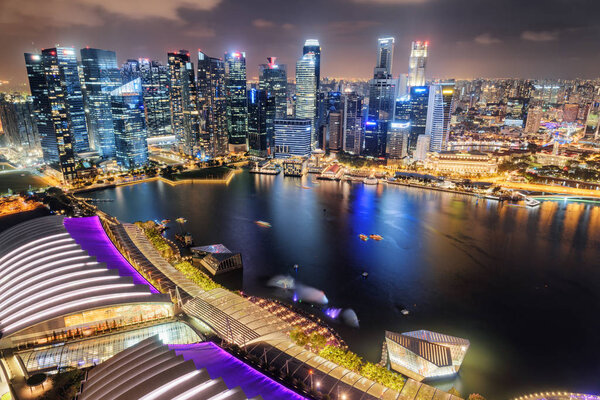 Amazing night aerial view of Marina Bay and skyscrapers of downtown. Awesome Singapore skyline. Fantastic cityscape. Singapore is a popular tourist destination of Asia.