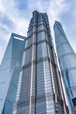 Shanghai, China - October 31, 2015: Amazing bottom view of the Shanghai Tower, the Jin Mao Tower and the Shanghai World Financial Center (SWFC) at the Pudong New Area (Lujiazui). clipart