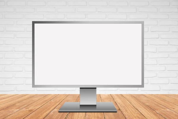 Moderner Computermonitor auf dem Holztisch mit weißer Ziegelwand — Stockfoto