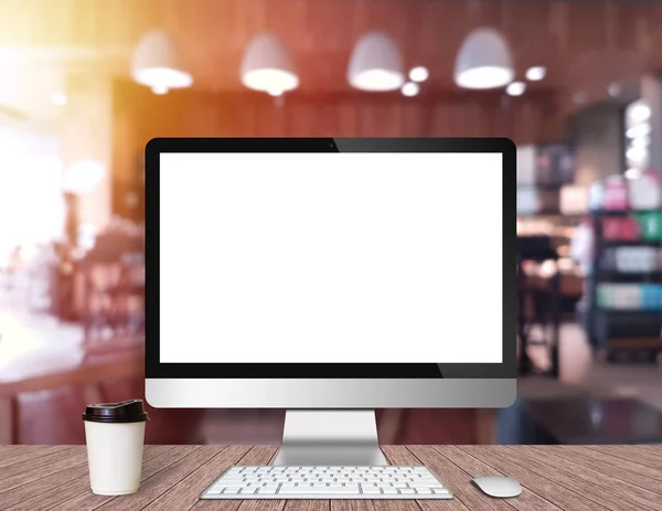 Modern Computer Monitor on a wooden desk with coffee shop backgr — Stock Photo, Image