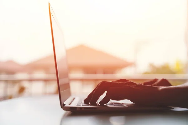 Close up of male hands typing on modern laptop keyboard