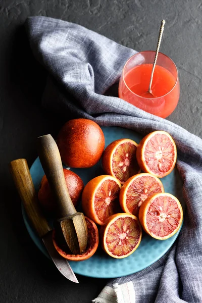 Rode Siciliaanse oranje stukken op blauw bord closeup — Stockfoto