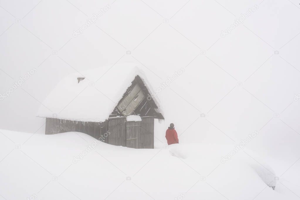 Minimalistic winter landscape with wooden house