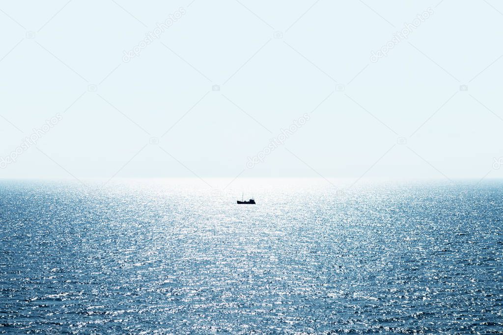 Lonely fishing ship trawler boat on ocean