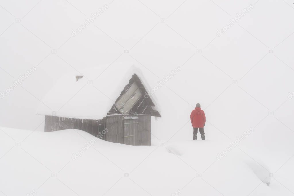 Minimalistic winter landscape with wooden house