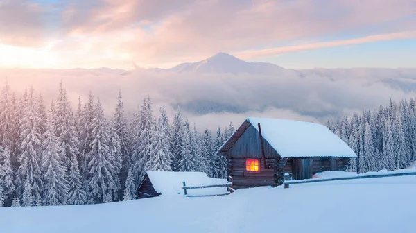 Fantástico paisaje invernal con casa de madera en montañas nevadas —  Fotos de Stock