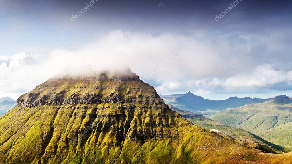 Foggy mountain peaks and clouds covering sea and mountains