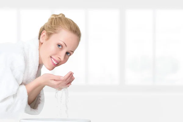 Young woman washing her face — Stock Photo, Image