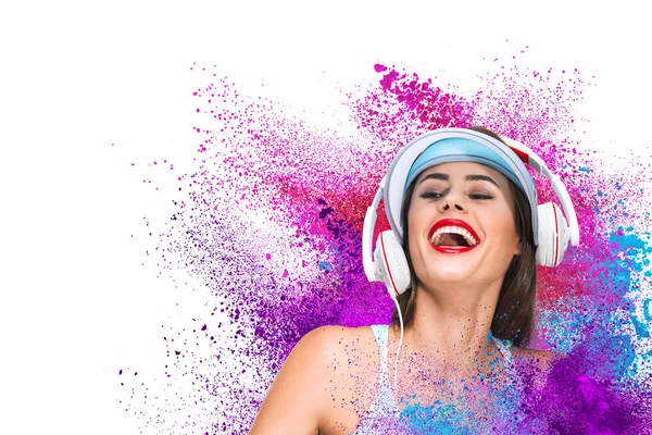 Happy young woman listening music in headphones — Stock Photo, Image