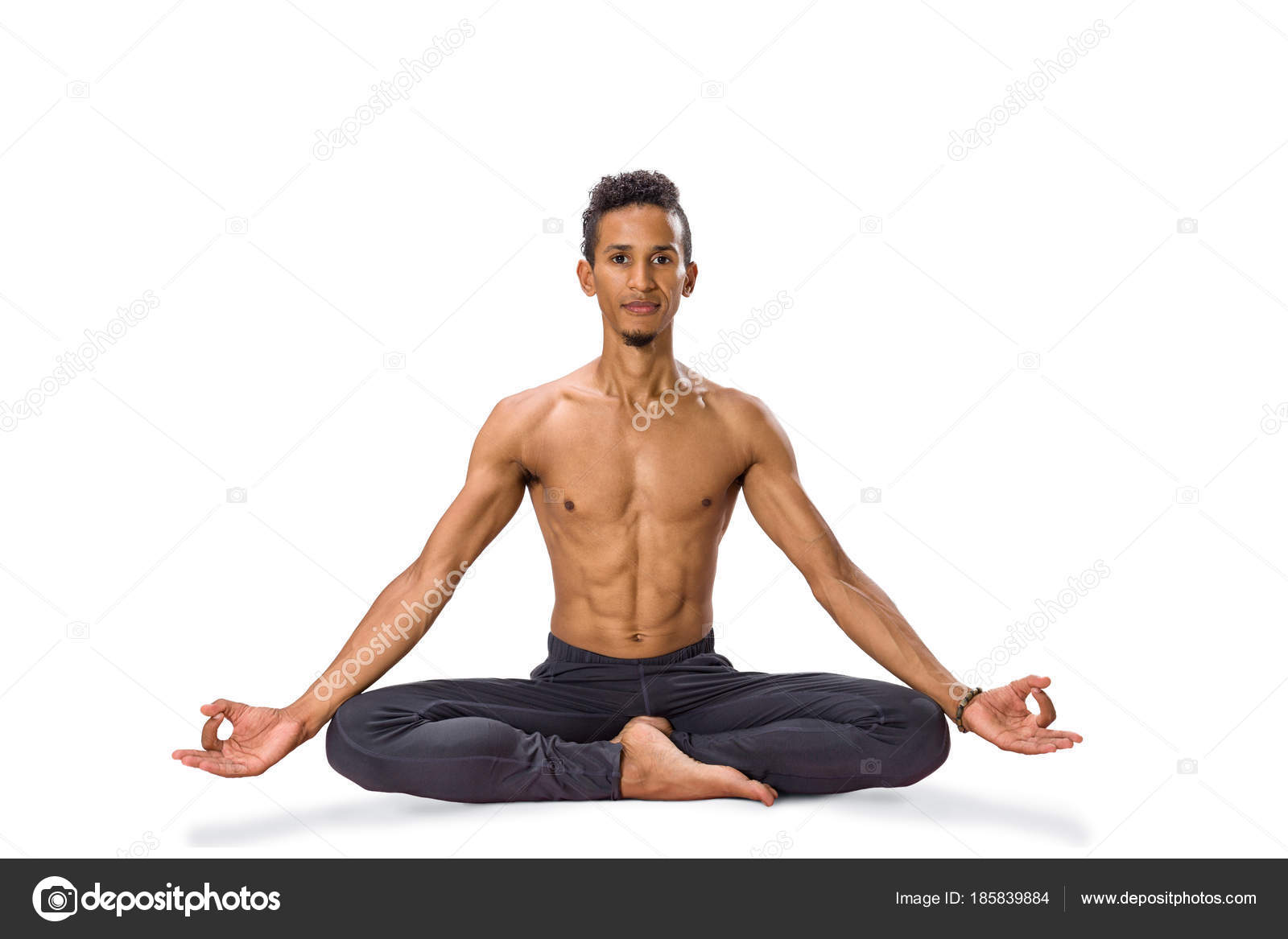 Young man meditating in Lotus position isolated Stock Photo by ©Avesun  185839884