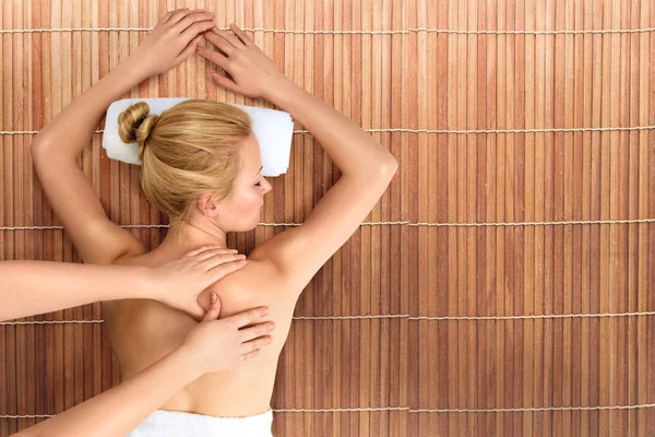 Young woman relaxing with massage in spa — Stock Photo, Image