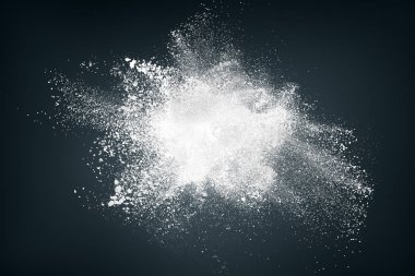 Abstract design of white powder snow particles cloud explosion over black background clipart
