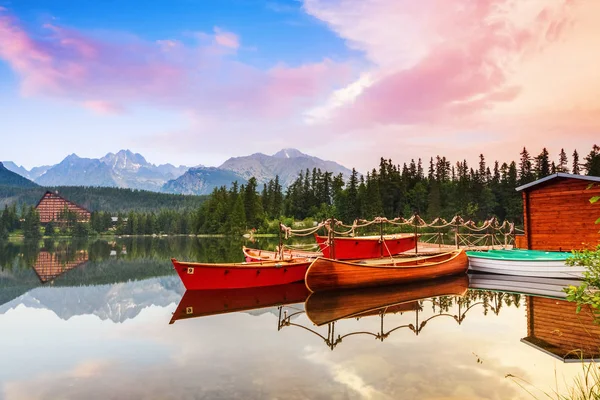 Magic lake with red boats and canoe.