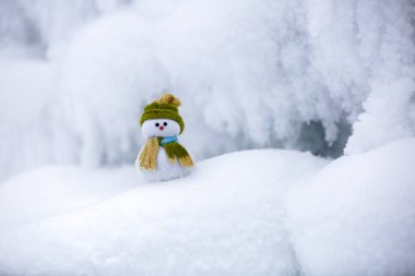 Kardan adam Noel Baba'nın Yardımcısı yeşil şapka duruyor.