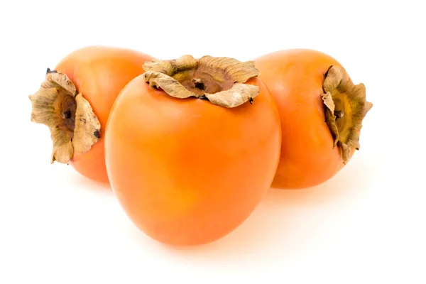 Three ripe persimmons on a white — Stock Photo, Image