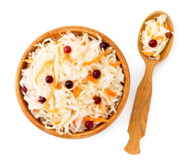 Ahşap tabakta kızılcıklı lahana turşusu ve beyaz kaşıkla. Zirvenin manzarası.