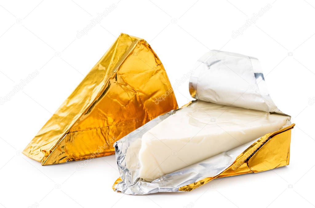 Cheese triangle in foil unpacked close-up on a white. Isolated