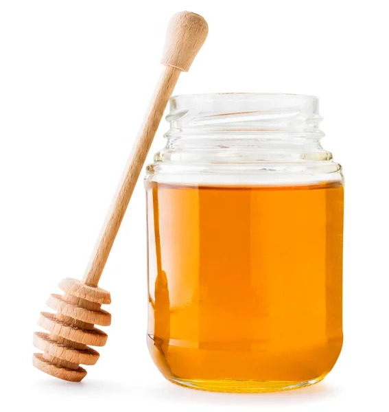 Miel en frasco con un agitador de madera sobre un fondo blanco. Aislado — Foto de Stock