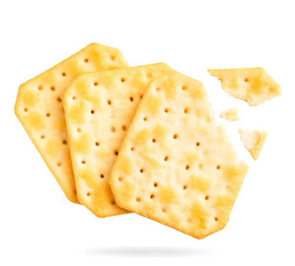 Crackers with broken pieces fly on a white. Isolated — Stock Photo, Image