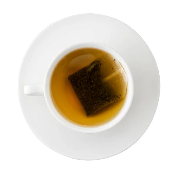 Una taza de té con una bolsa de té y un platillo en un blanco. Aislado —  Fotos de Stock