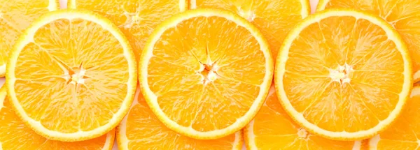 Orange fruit cut into circles background. The view of the top. — Stock Photo, Image