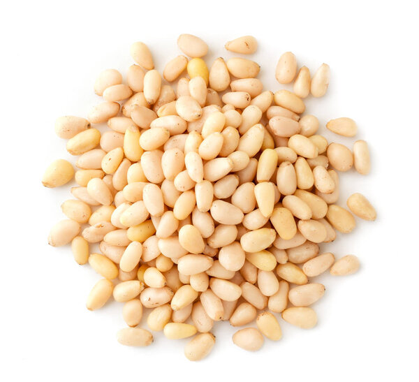 Pile of pine nuts on a white, isolated. The view of the top.