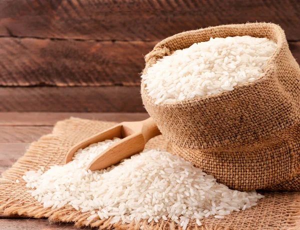 Rice spills out of a bag. Background — Stock Photo, Image