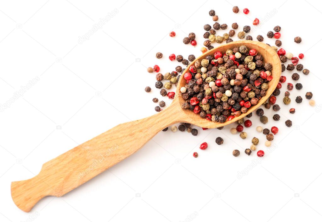 Mix peppercorns in a wooden spoon close-up on a white background, isolated. The view from top