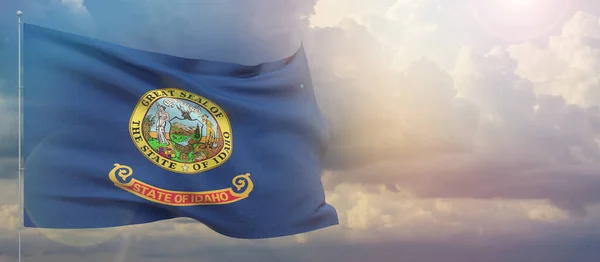 Flaggor från Usa. Delstaten Idaho flagga. Viftande flagga på solnedgång himmel bakgrund 3d illustration. — Stockfoto
