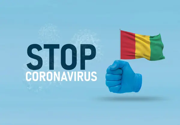 COVID-19 Visual concept - hand-text Stop Coronavirus, hand-gesture versus virus infection, clenched fist holds flag of Guinea. Pandemic 3D illustration. — Stock Photo, Image