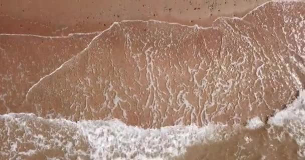 Vista dall'alto verso il basso delle onde che si infrangono sulla sabbia, che sorvolano la spiaggia di sabbia tropicale e le onde — Video Stock