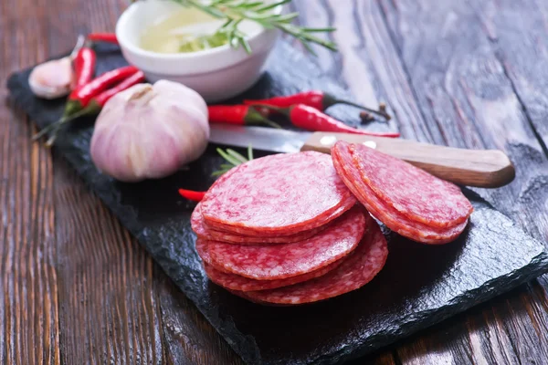 Sliced salami on board — Stock Photo, Image