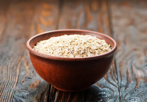 Oat bran in bowl — Stock Photo, Image