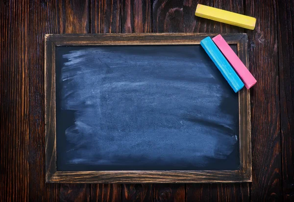 Black board and chalks — Stock Photo, Image