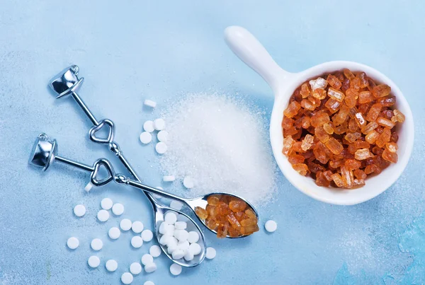 Variations of sugar on blue table — Stock Photo, Image