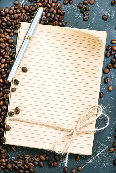 Coffee beans and notebook — Stock Photo, Image