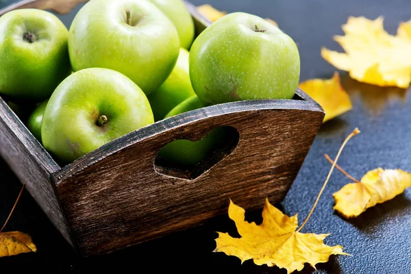 Ripe apples on a table in wooden basket — Stock Photo, Image