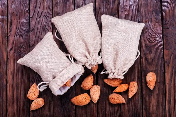 Amandes en sac et sur une table — Photo