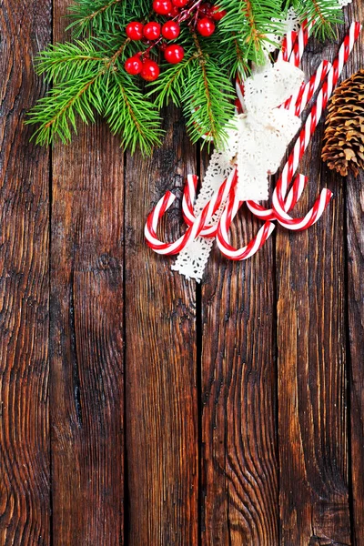 Candy canes and christmas fir branch — Stock Photo, Image
