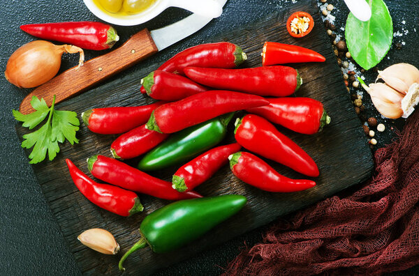 aroma spices on a table, chilli peppers and aroma oil