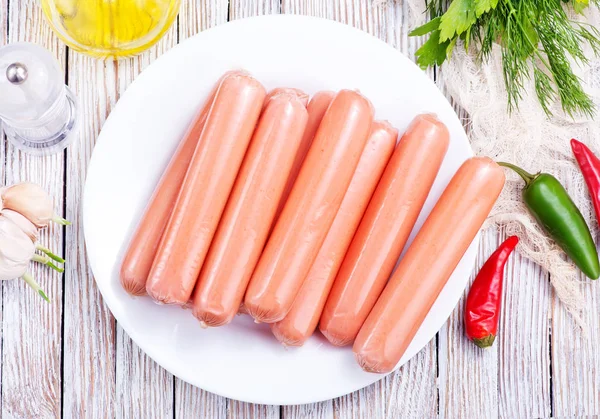 Raw sausages on plate — Stock Photo, Image