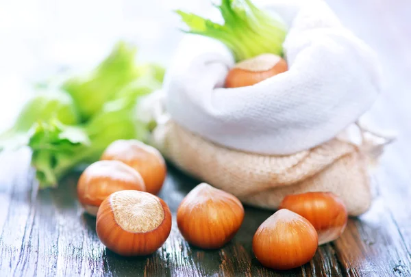 Hazelnuts on wooden table — Stock Photo, Image