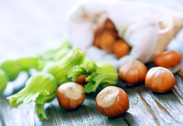 Hazelnuts on wooden table — Stock Photo, Image