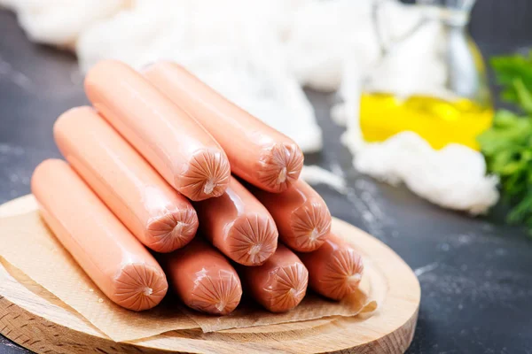 Raw sausages on board — Stock Photo, Image